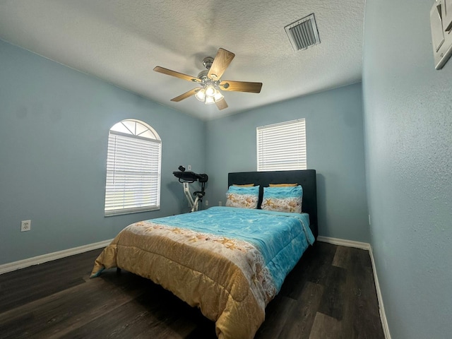 2410 Sweetwater Blvd, Saint Cloud, FL 34772 - bedroom with baseboards, wood finished floors, a ceiling fan, and a textured ceiling