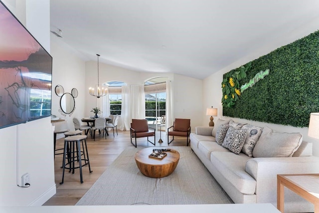 344 High Point Dr, Davenport, FL 33837 - living area featuring light wood-style flooring, lofted ceiling, and a chandelier