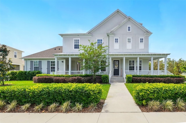 7400 Estuary Lake Loop, Celebration, FL 34747 - greek revival house featuring a porch and stucco siding
