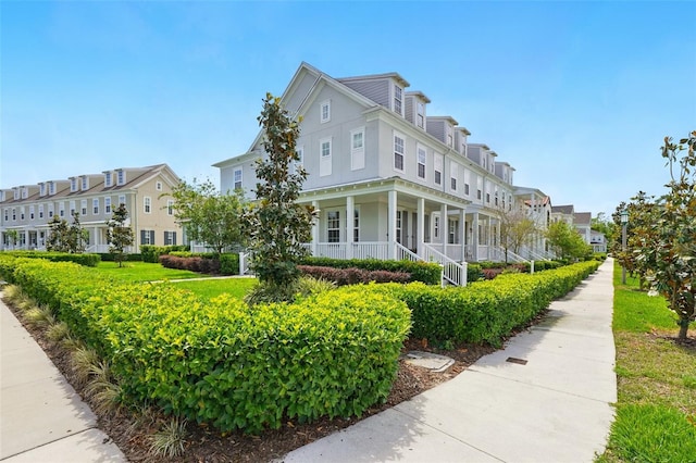 7400 Estuary Lake Loop, Celebration, FL 34747 - view of side of home with a porch, stucco siding, and a residential view