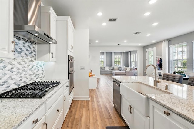 7400 Estuary Lake Loop, Celebration, FL 34747 - kitchen featuring wall chimney exhaust hood, appliances with stainless steel finishes, open floor plan, healthy amount of natural light, and recessed lighting