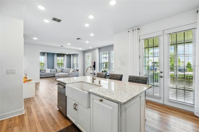 7400 Estuary Lake Loop, Celebration, FL 34747 - kitchen with a kitchen island with sink, white cabinetry, open floor plan, light wood-type flooring, and recessed lighting