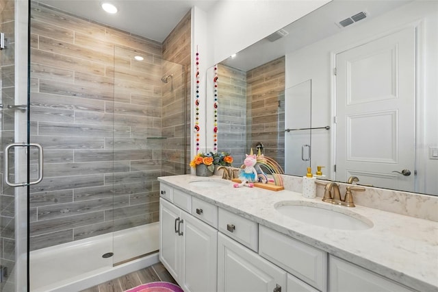7400 Estuary Lake Loop, Celebration, FL 34747 - bathroom featuring double vanity, a shower stall, and recessed lighting