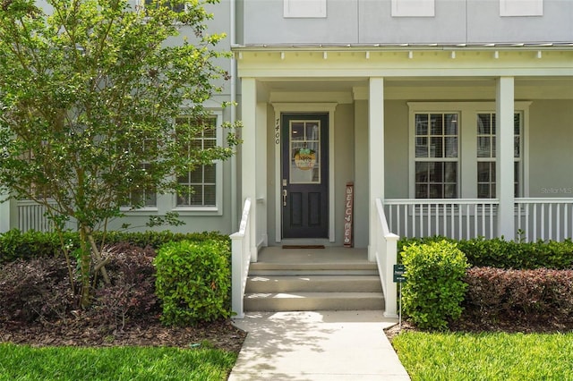7400 Estuary Lake Loop, Celebration, FL 34747 - property entrance featuring stucco siding and a porch
