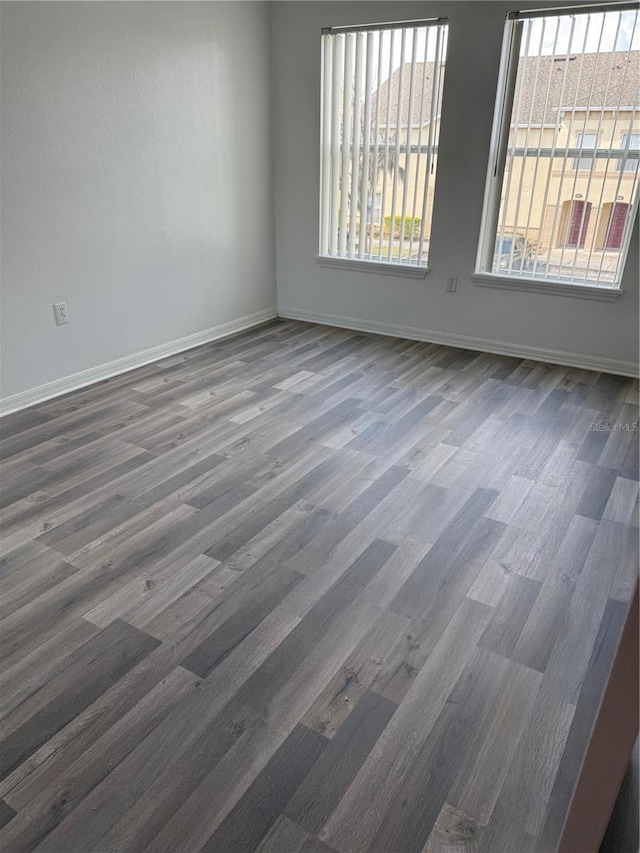 2826 Club Cortile Cir Unit B, Kissimmee, FL 34746 - empty room featuring wood finished floors, baseboards, and healthy amount of natural light