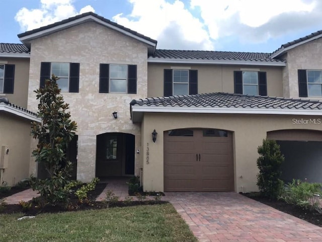 13885 Arclid St, Orlando, FL 32832 - multi unit property with a tile roof, a garage, and decorative driveway