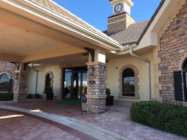 13885 Arclid St, Orlando, FL 32832 - doorway to property featuring stone siding and stucco siding