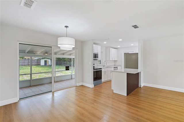 818 Ballard St, Altamonte Springs, FL 32701 - kitchen featuring stainless steel appliances, light countertops, white cabinets, baseboards, and recessed lighting