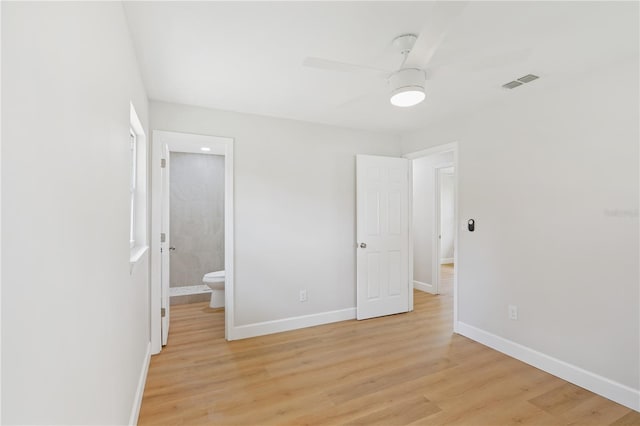 818 Ballard St, Altamonte Springs, FL 32701 - unfurnished bedroom featuring baseboards, light wood-style flooring, and connected bathroom