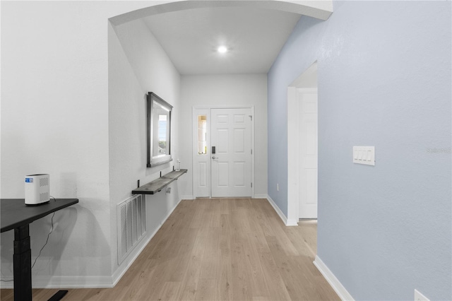 1524 Fleur Dr, Davenport, FL 33837 - foyer entrance featuring light wood-style floors, arched walkways, and baseboards
