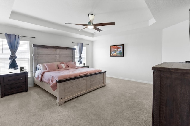 1524 Fleur Dr, Davenport, FL 33837 - bedroom featuring a tray ceiling, light colored carpet, baseboards, and ceiling fan