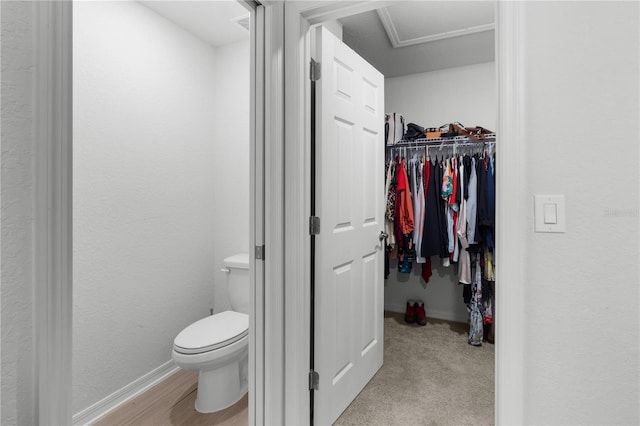 1524 Fleur Dr, Davenport, FL 33837 - bathroom featuring toilet, baseboards, and a walk in closet