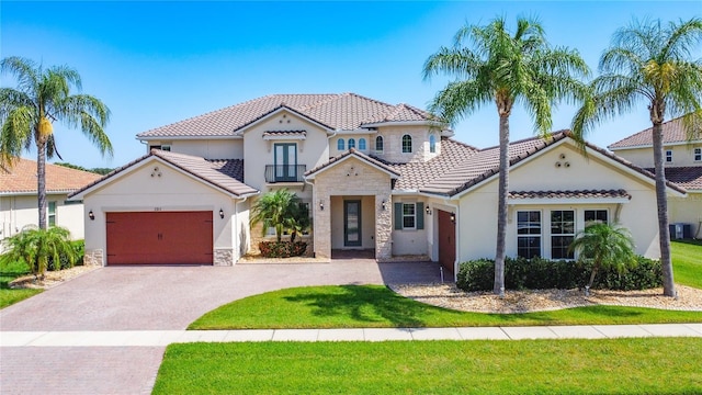 1211 Terralago Way, Kissimmee, FL 34746 - mediterranean / spanish home with stone siding, asphalt driveway, a garage, a tile roof, and stucco siding