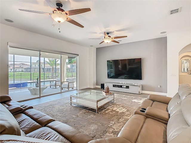 1211 Terralago Way, Kissimmee, FL 34746 - living area featuring a ceiling fan, baseboards, and arched walkways