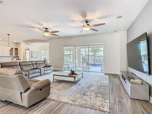 1211 Terralago Way, Kissimmee, FL 34746 - living area with ceiling fan, wood finish floors, and baseboards