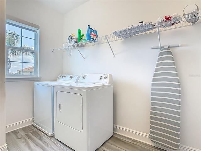 1211 Terralago Way, Kissimmee, FL 34746 - washroom with washer and clothes dryer, baseboards, and light wood-style floors