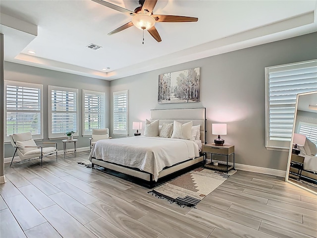1211 Terralago Way, Kissimmee, FL 34746 - bedroom featuring a tray ceiling, baseboards, wood finish floors, and recessed lighting