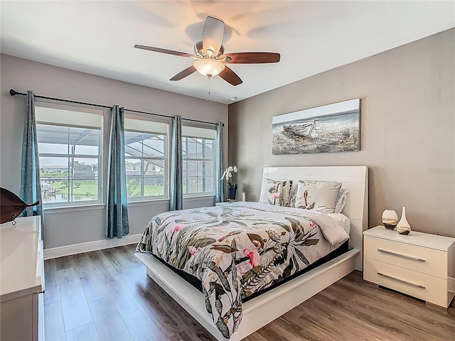 1211 Terralago Way, Kissimmee, FL 34746 - bedroom featuring wood finished floors, ceiling fan, and baseboards