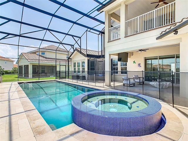 1211 Terralago Way, Kissimmee, FL 34746 - view of swimming pool featuring ceiling fan, a patio, a pool with connected hot tub, and glass enclosure