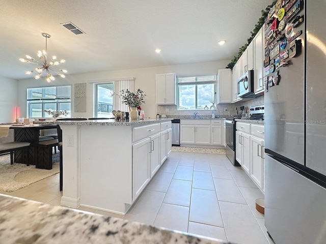 895 Overpool Ave, Davenport, FL 33896 - kitchen featuring appliances with stainless steel finishes, plenty of natural light, a center island, a chandelier, and recessed lighting