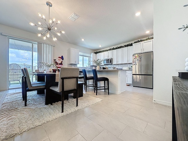 895 Overpool Ave, Davenport, FL 33896 - dining room with a chandelier, light tile patterned flooring, baseboards, and recessed lighting