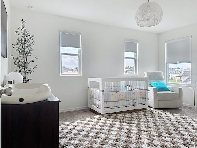 895 Overpool Ave, Davenport, FL 33896 - carpeted bedroom featuring multiple windows, a nursery area, and baseboards