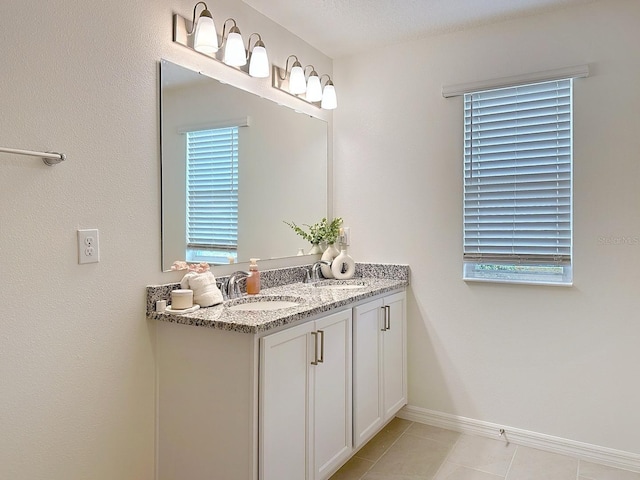 895 Overpool Ave, Davenport, FL 33896 - bathroom with vanity, tile patterned floors, and baseboards