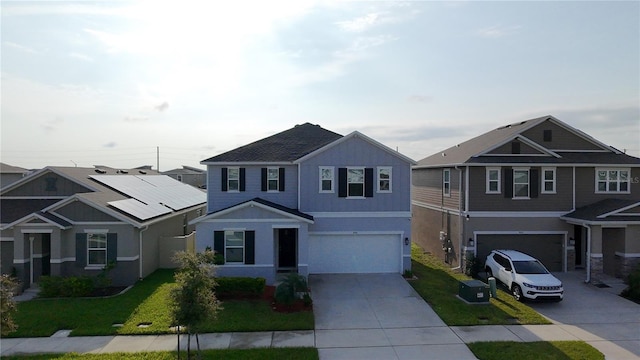 895 Overpool Ave, Davenport, FL 33896 - view of front of house with concrete driveway, a garage, stucco siding, and a front yard