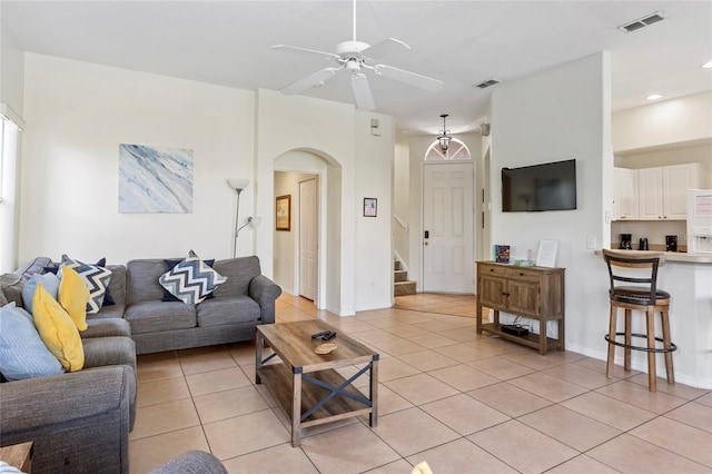 833 Brunello Dr, Davenport, FL 33897 - living room featuring light tile patterned floors, arched walkways, ceiling fan, stairway, and recessed lighting