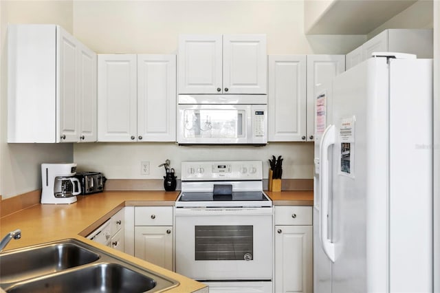 833 Brunello Dr, Davenport, FL 33897 - kitchen featuring white appliances, a sink, white cabinets, and light countertops