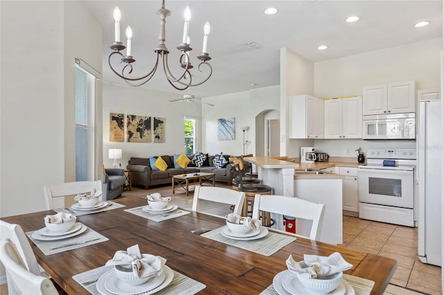 833 Brunello Dr, Davenport, FL 33897 - dining space featuring arched walkways, a chandelier, ceiling fan, recessed lighting, and light tile patterned floors