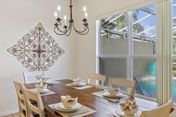 833 Brunello Dr, Davenport, FL 33897 - dining area featuring a chandelier and wood finished floors