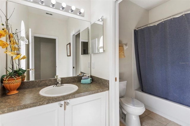833 Brunello Dr, Davenport, FL 33897 - full bathroom with toilet, vanity, tile patterned flooring, and shower / bath combo with shower curtain