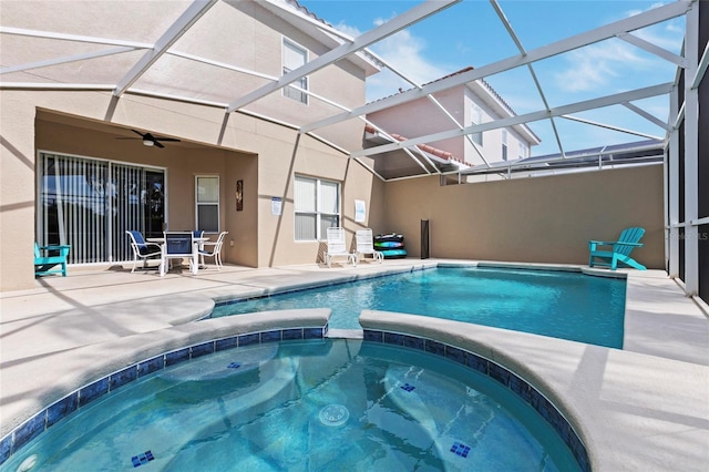 833 Brunello Dr, Davenport, FL 33897 - view of pool featuring a patio area, a ceiling fan, a pool with connected hot tub, outdoor dining space, and glass enclosure
