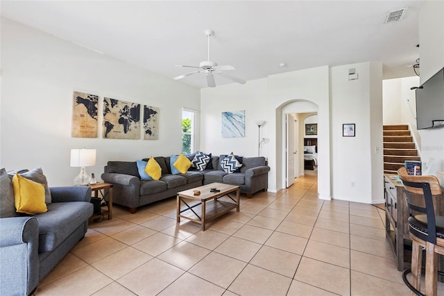 833 Brunello Dr, Davenport, FL 33897 - living area featuring a ceiling fan, arched walkways, light tile patterned floors, and stairs