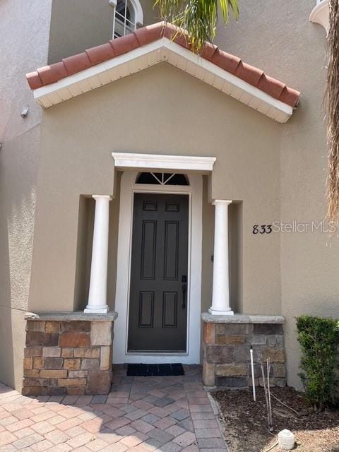 833 Brunello Dr, Davenport, FL 33897 - entrance to property with stone siding and stucco siding