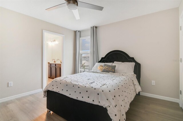 8042 Glenlloyd Ave, Winter Garden, FL 34787 - bedroom with light wood-type flooring, baseboards, a ceiling fan, and connected bathroom
