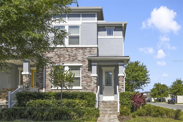 8042 Glenlloyd Ave, Winter Garden, FL 34787 - view of front facade featuring stucco siding and stone siding