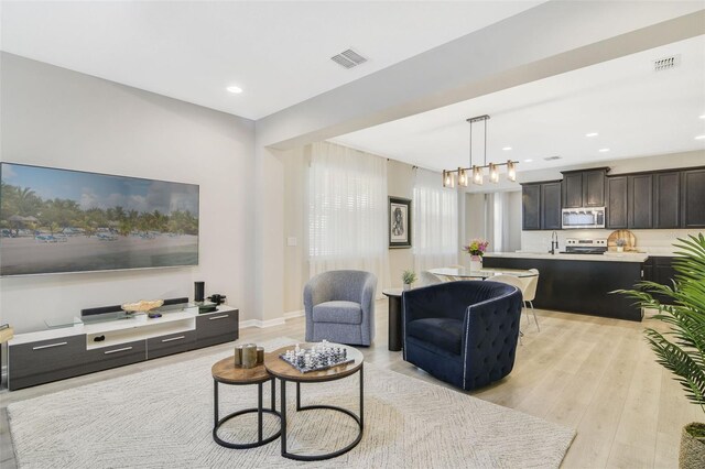 8042 Glenlloyd Ave, Winter Garden, FL 34787 - living area featuring light wood-style flooring and recessed lighting