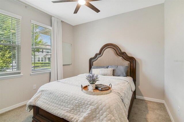 8042 Glenlloyd Ave, Winter Garden, FL 34787 - bedroom with carpet floors, baseboards, and a ceiling fan