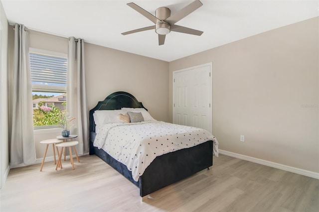 8042 Glenlloyd Ave, Winter Garden, FL 34787 - bedroom with light wood finished floors, baseboards, and a ceiling fan