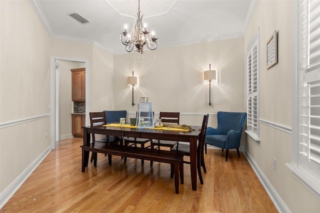 3349 Schoolhouse Rd, Harmony, FL 34773 - dining room featuring a chandelier, light wood-type flooring, ornamental molding, and baseboards