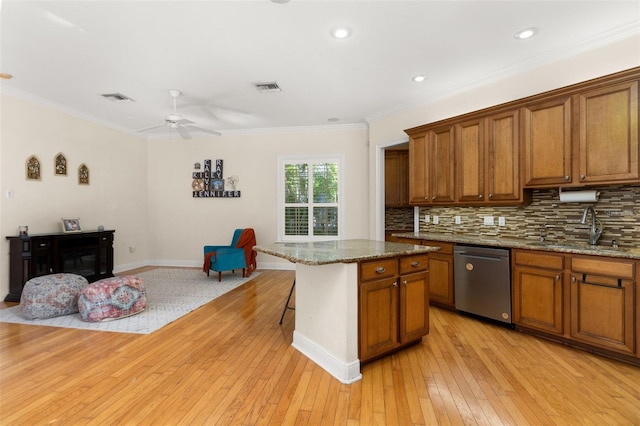 3349 Schoolhouse Rd, Harmony, FL 34773 - kitchen with dishwasher, a sink, brown cabinetry, ceiling fan, and ornamental molding
