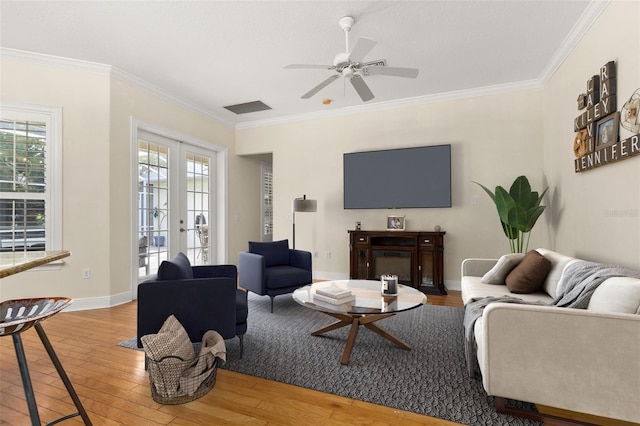 3349 Schoolhouse Rd, Harmony, FL 34773 - living area with wood finished floors, french doors, ceiling fan, crown molding, and baseboards