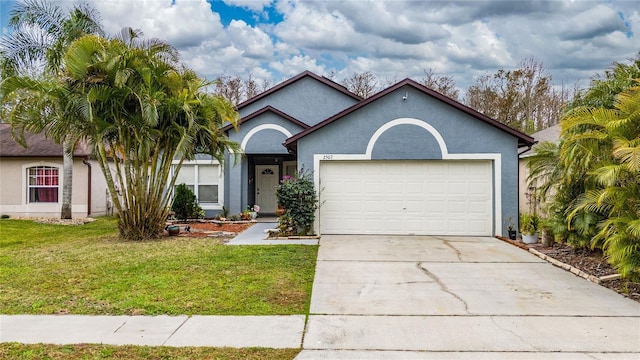 2507 Talega Dr, Saint Cloud, FL 34772 - single story home featuring a front lawn, stucco siding, driveway, and an attached garage