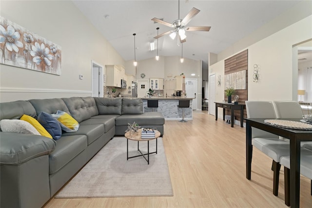 2507 Talega Dr, Saint Cloud, FL 34772 - living room featuring ceiling fan, light wood finished floors, and high vaulted ceiling
