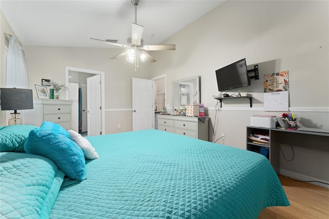 2507 Talega Dr, Saint Cloud, FL 34772 - bedroom featuring wood finished floors, vaulted ceiling, a ceiling fan, and ensuite bath
