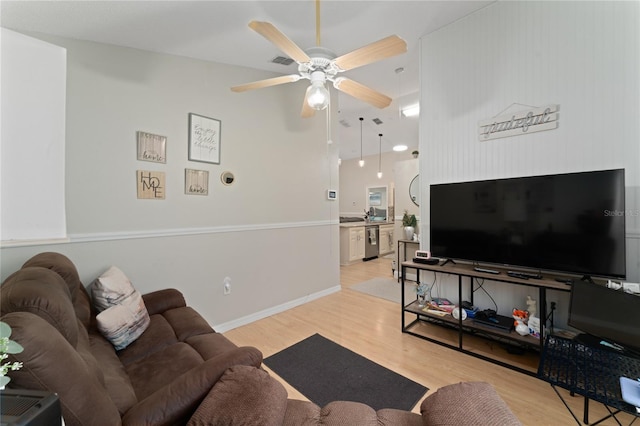 2507 Talega Dr, Saint Cloud, FL 34772 - living room featuring light wood-style flooring, a ceiling fan, and a towering ceiling