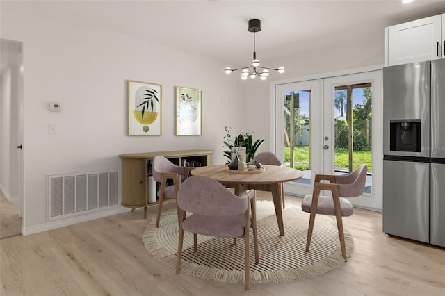 1842 Puritan Ave, Winter Park, FL 32792 - dining space featuring french doors, light wood-type flooring, a chandelier, and baseboards