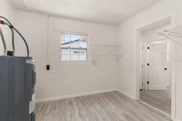 1842 Puritan Ave, Winter Park, FL 32792 - laundry room with water heater, wood finished floors, and baseboards